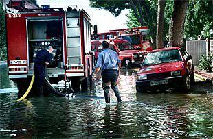 Los bomberos achicaban ayer agua en uno de los márgenes de la autopista.