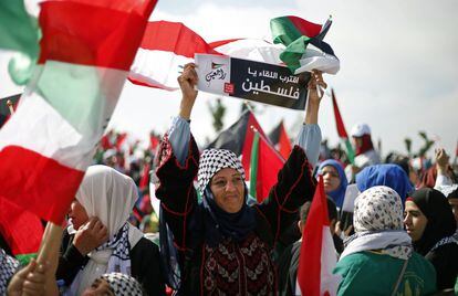 Una mujer palestina refugiada en el Líbano muestra una pancarta que lee en árabe "Nos encontraremos pronto Palestina, volveremos", durante una protesta en Líbano cerca de la frontera con Israel.