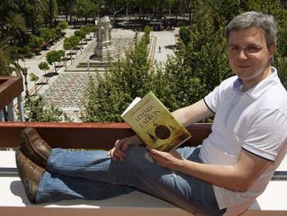Juan Gómez-Jurado sostiene un ejemplar de su novela en Sevilla.