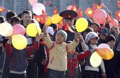 Varios niños observan el desfile de estudiantes del instituto de policía de Kirguizistánm durante los preparativos para las elecciones en Bishkek, la capital.