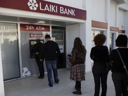 Clientes del Laiki Bank de Larnaca (Chipre) hacen cola en el cajero autom&aacute;tico, ayer s&aacute;bado por la ma&ntilde;ana